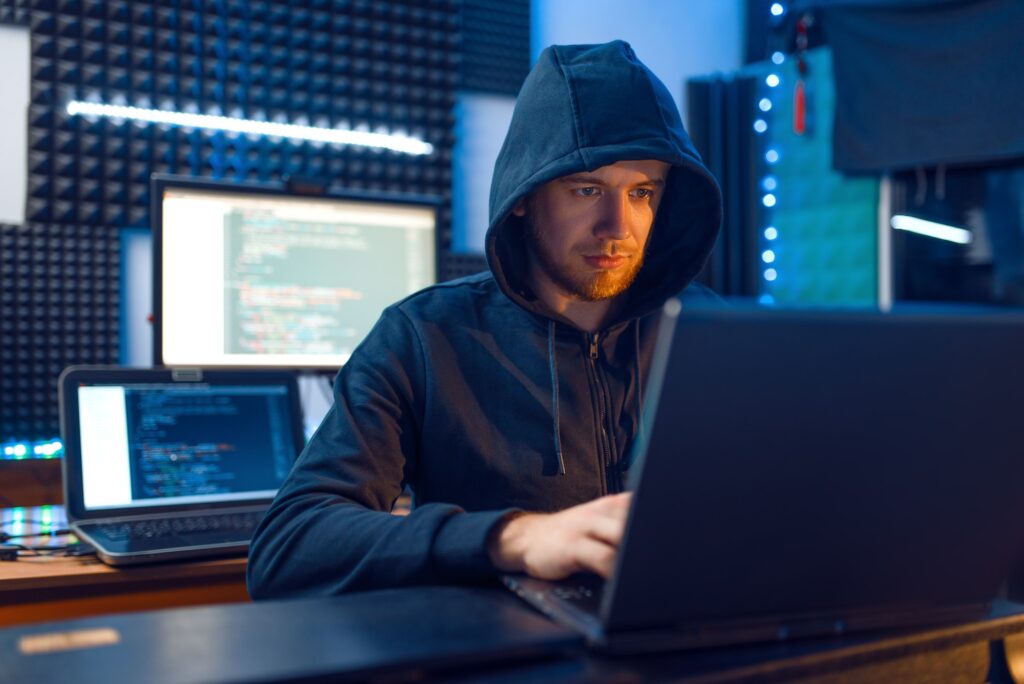 Hacker in hood, network criminal, darknet user