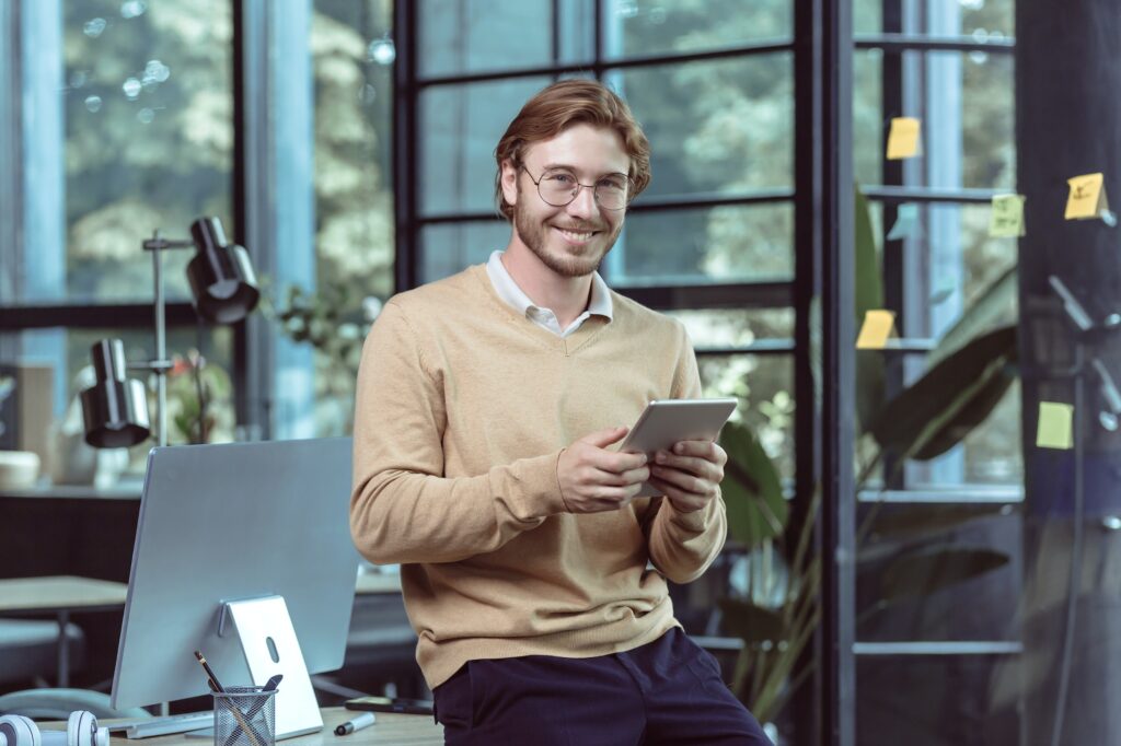 Portrait of young businessman businessman man blond smiling and looking at camera.