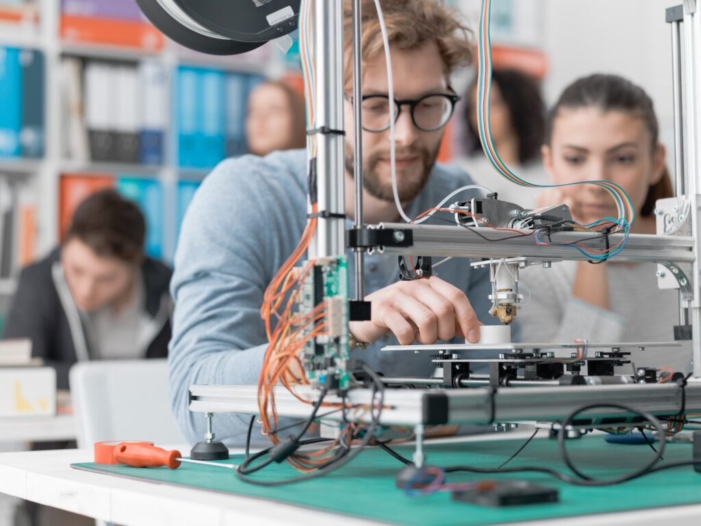 Students using a 3D printer